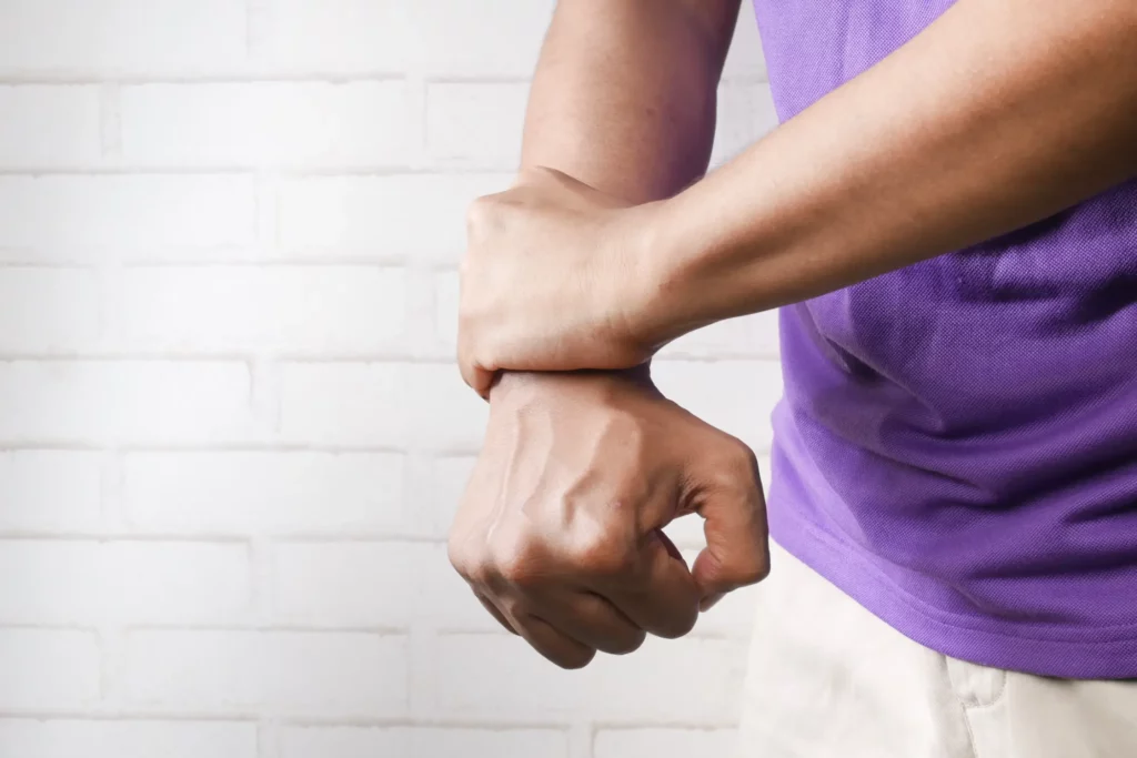 image of person holding their wrist in pain