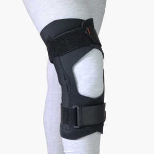 TheraCore | TheraCore,Sustainable orthopaedic materials,NHS net zero supplier,PFAS-free orthopaedic materials,Low-carbon medical manufacturing Studio shot of the black TheraCore wraparound knee brace secured on a leg, showing its low-profile, anatomical design.