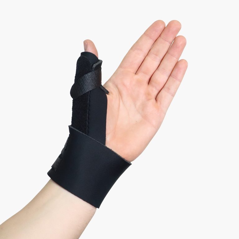 Person wearing a black TheraCore Thumb Spica brace on their hand to support the thumb joint and wrist.