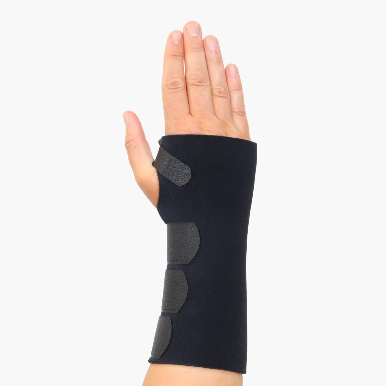 TheraCore Universal Extended Wrist Brace shown on a hand with palm facing forward, displaying the adjustable hook straps and secure fit.
